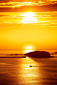 Scenic view of sea against romantic sky at sunset