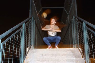 Low angle view of man walking on footbridge