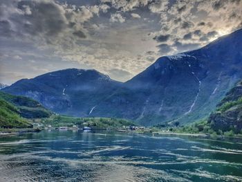 Scenic view of lake and mountains against sky