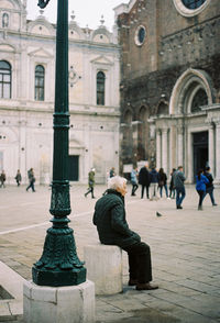 Rear view of woman at temple against sky