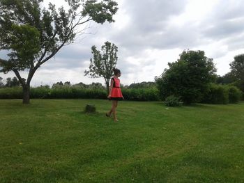 Man standing on golf course against sky