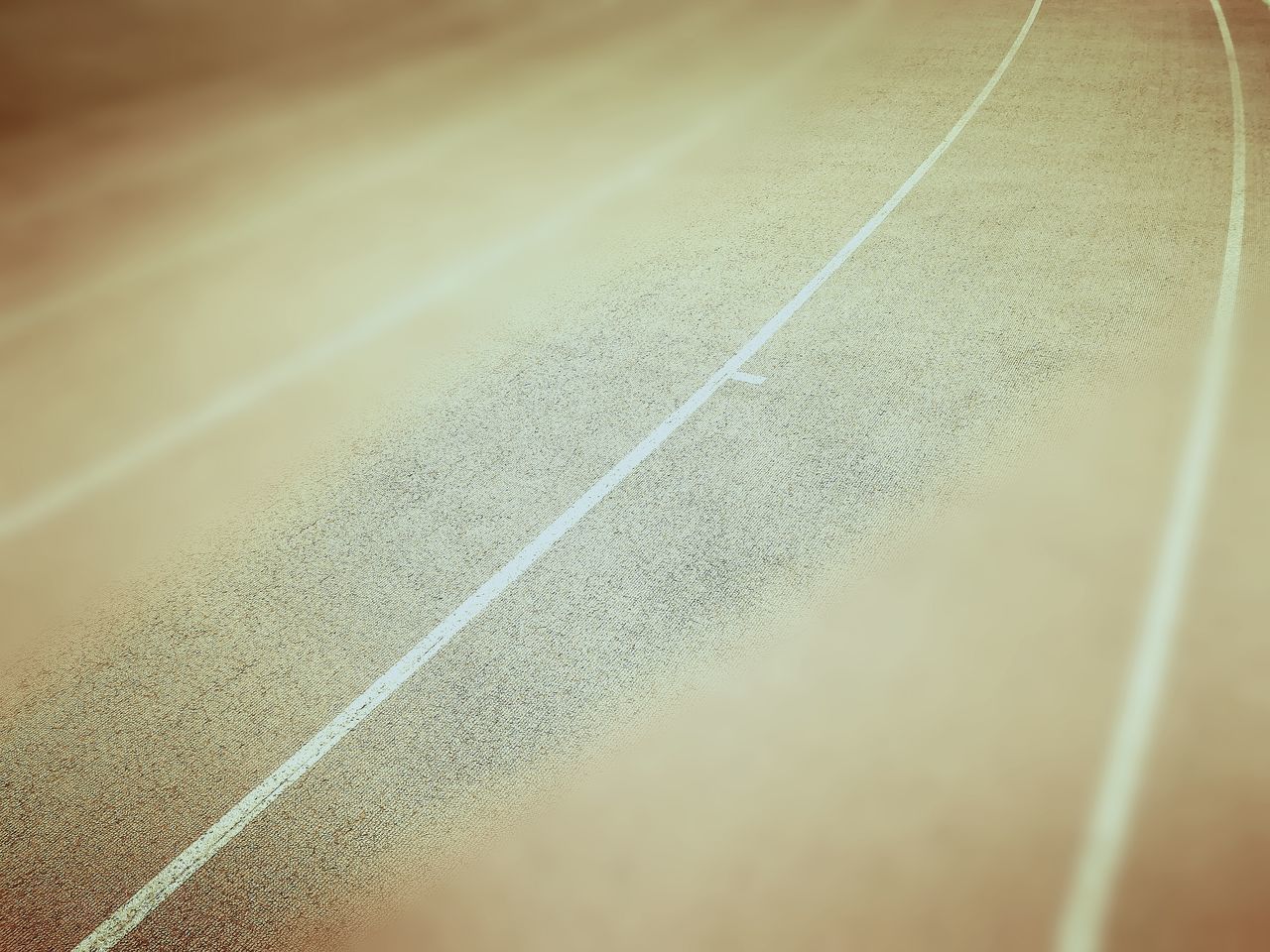 CLOSE-UP OF ROAD IN SUNLIGHT