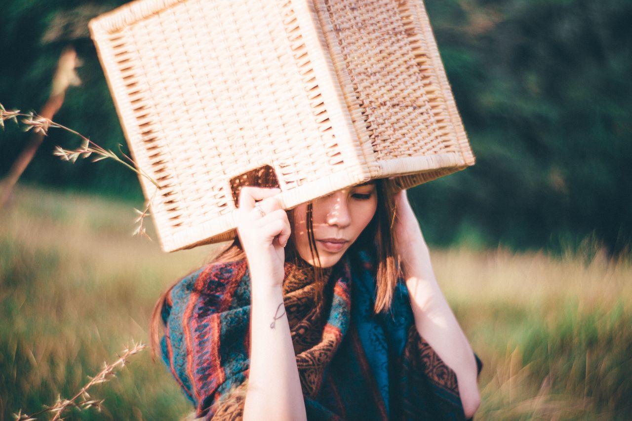 lifestyles, leisure activity, young adult, person, casual clothing, holding, young women, waist up, focus on foreground, three quarter length, front view, day, photographing, happiness, built structure, outdoors, building exterior, headshot