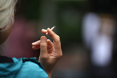 Cropped image of person holding cigarette