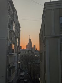 Buildings in city against sky during sunset