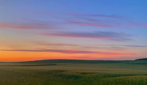 Scenic view of field against sky during sunset