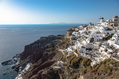 High angle view of town by sea against clear sky