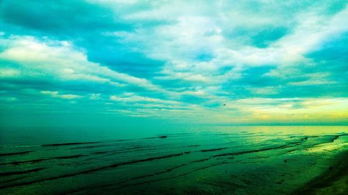 View of beach against cloudy sky