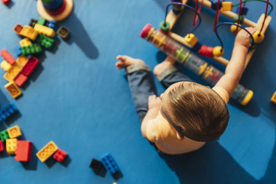 High angle view of boy playing with toy