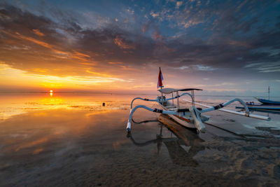 Scenic view of beach against sky during sunset