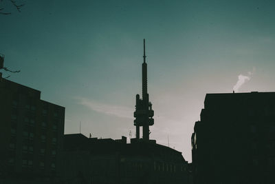 Low angle view of silhouette buildings against sky