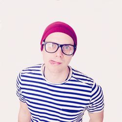 Portrait of mature man wearing hat against white background