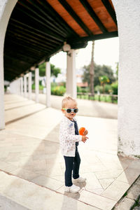 Full length of boy standing in city