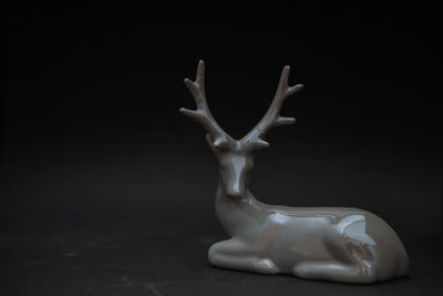 Close-up of animal sculpture against black background