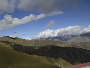 Scenic view of mountains against cloudy sky