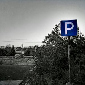 Information sign on street against clear sky