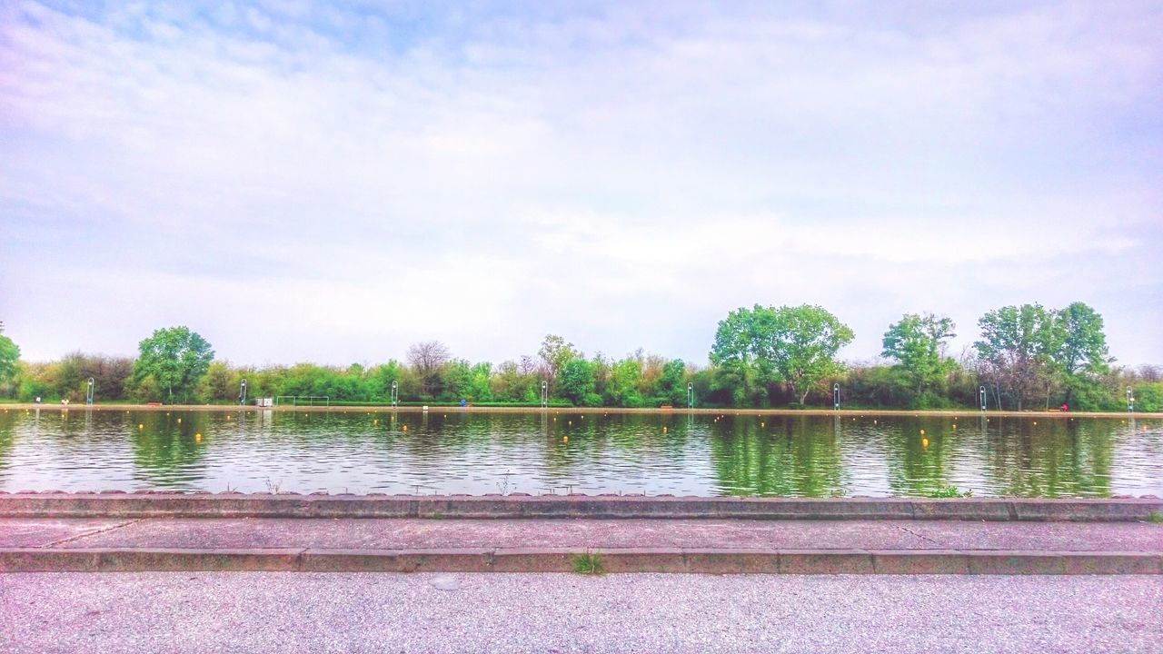 water, tree, sky, tranquility, tranquil scene, lake, beauty in nature, reflection, nature, cloud - sky, scenics, growth, blue, cloud, river, day, outdoors, idyllic, railing, no people