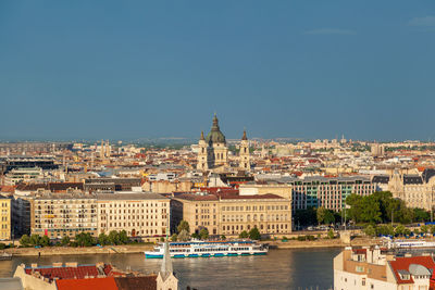 Buildings in city against clear sky