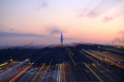 High angle view of light trails amidst buildings in city