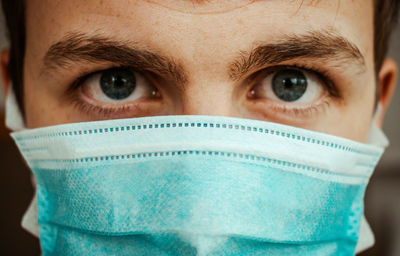 Close-up portrait of man wearing mask