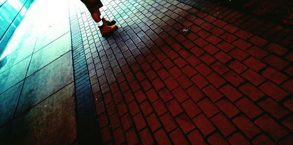 Low section of woman standing on tiled floor