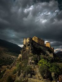 Low angle view of historic building against cloudy sky