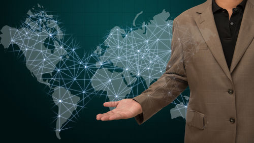 Digital composite image of man over world map