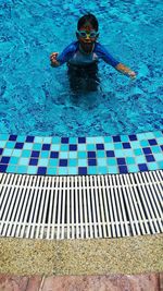 High angle view of boy swimming in pool