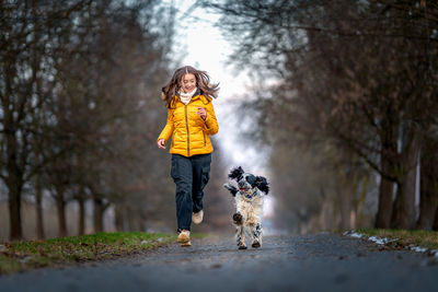 Full length of young woman walking in forest