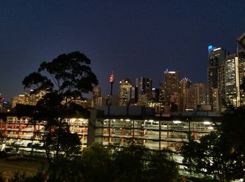 Illuminated buildings against sky at night