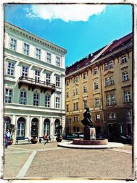 Buildings against cloudy sky