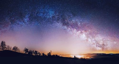 Scenic view of field against star field