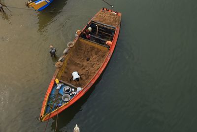 High angle view of people working in boat on lake