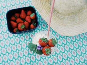 High angle view of strawberries in ice cream on table