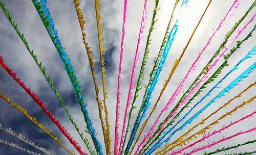 Low angle view of multi colored decoration hanging against sky