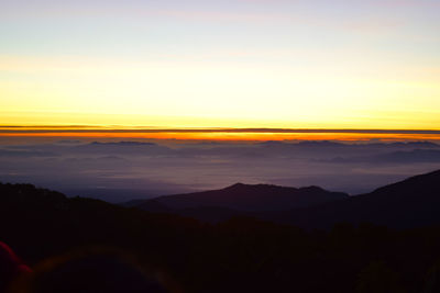 Scenic view of silhouette mountains against sky at sunset