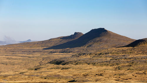 Scenic view of arid landscape against sky