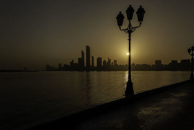 Abu dhabi cityscape silhouette during sunrise