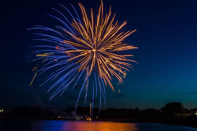 Low angle view of firework display at night