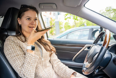 Young woman sitting in car