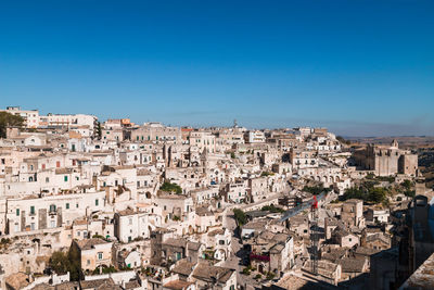 Aerial view of townscape against clear blue sky