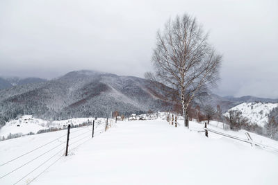 Snow covered landscape against sky