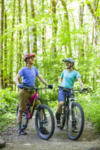 Two female bikers enjoy a trail in sandy, or near mt. hood.