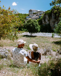 Rear view of people sitting on plants