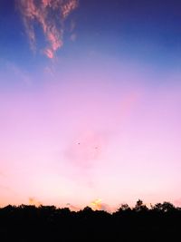 Silhouette trees against sky during sunset