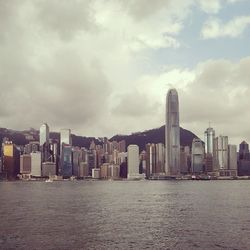 Cityscape against cloudy sky