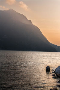 Scenic view of sea and mountains against sky