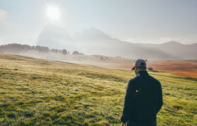 Man standing on field against sky