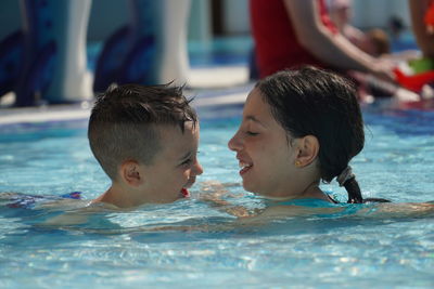 Portrait of boy swimming in pool