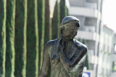 Close-up of statue against trees in forest